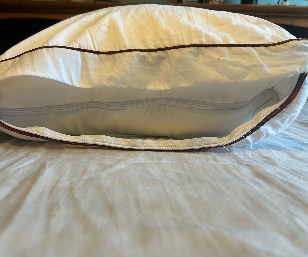 Images of the Saatva Latex pillow close up and from the side to demonstrate testing for a review