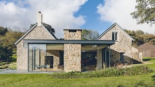 a stone cottage with a contemporary glazed extension