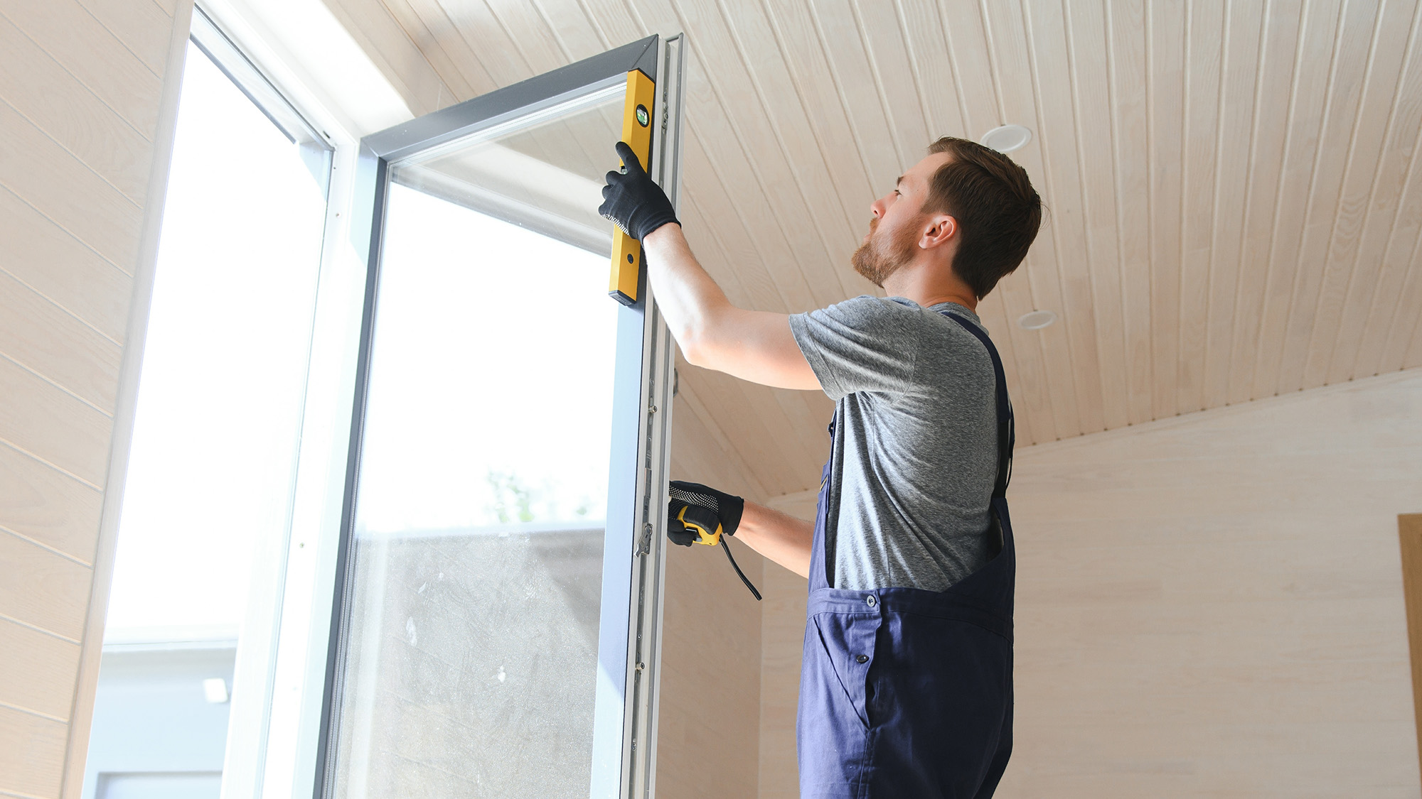Construction worker replacing window