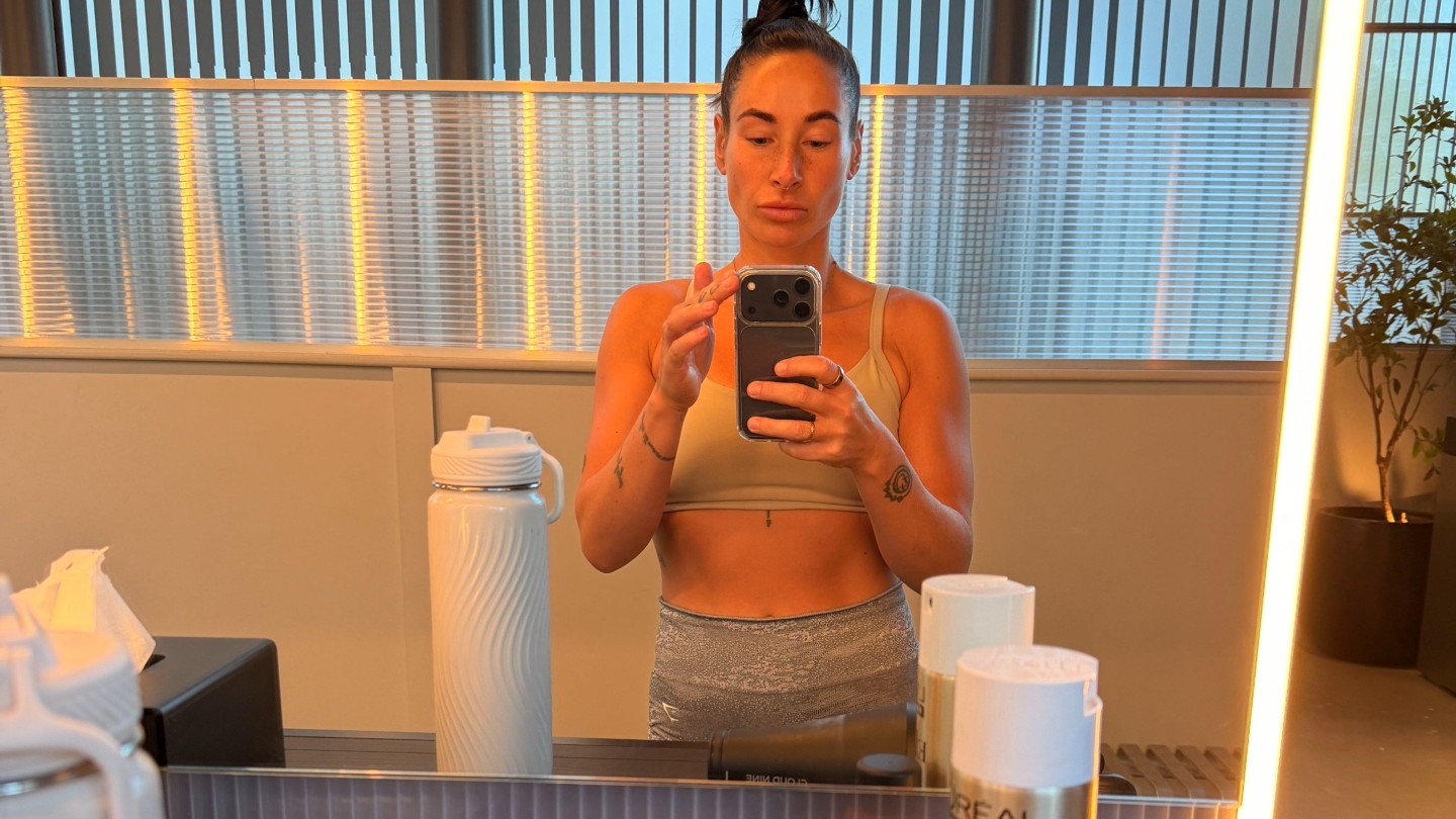 Writer Sam posing in the mirror during a workout