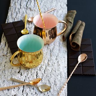 gold and copper mugs spoons and chocolate bar
