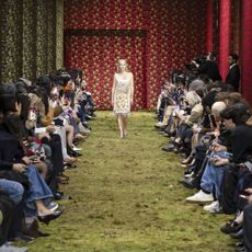 Gillian Anderson walks the runway during the Miu Miu Ready to Wear Fall/Winter 2026-2027 fashion show as part of Paris Fashion Week with moss on the runway