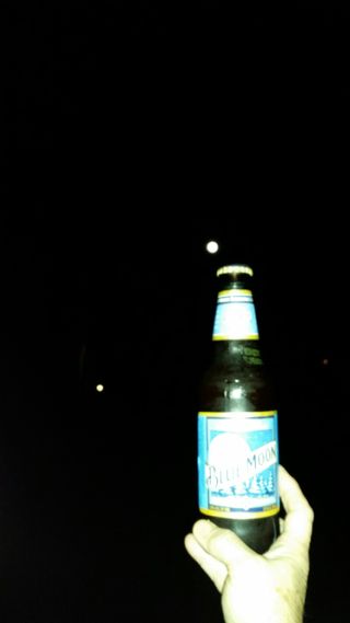 The Blue Moon full moon and a Blue Moon beer share this image from skywatcher Elisa Barnes-Shizak of Caledonia Mississippi on July 31, 2015. The Blue Moon Brewing Company celebrated its 20th anniversary during the lunar event.