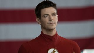 Barry Allen in front of a giant flag on The Flash