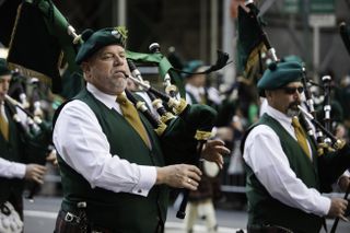 Bag pipe player marching in New York City St. Patrick's Day parade.