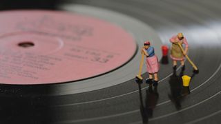 Model people cleaning record surface