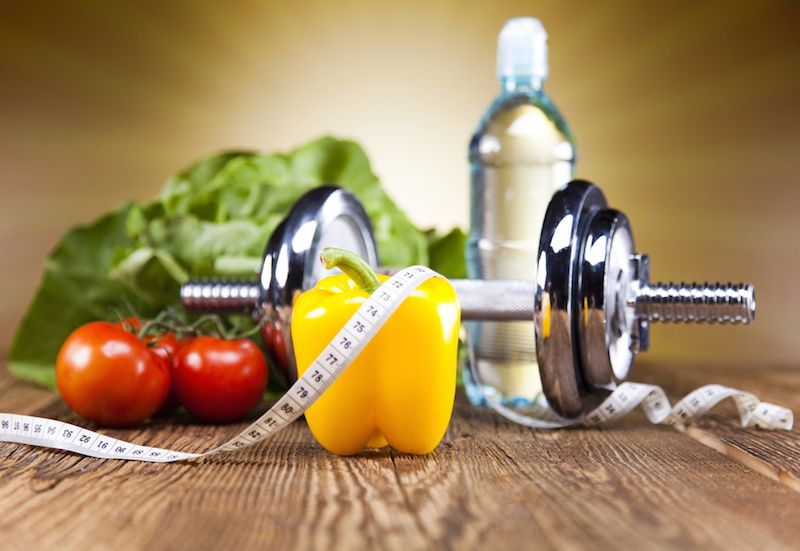 An image shows the components of a healthy lifestyle -- vegetables, water, and a dumbell