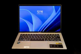 An Acer Swift Go 14 OLED laptop on a black background