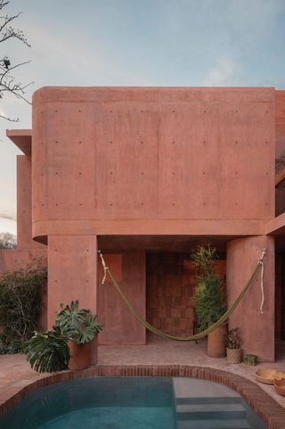 casa roja, a red house by angel garcia in mexico with indoor outdoor areas and terraces anda brutalist exposed concrete in red tone