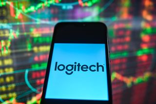 Logitech logo seen displayed on a smartphone with stock market percentages in the background