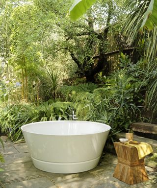 Outdoor bathtub in a leafy garden