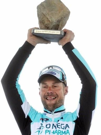Tom Boonen still has plenty of strength left to hoist the cobblestone trophy aloft on the podium.
