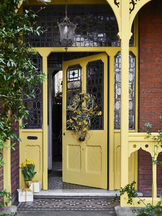 yellow front door and porch