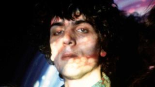 Syd Barrett in 1967, his face lit by psychedelic lights