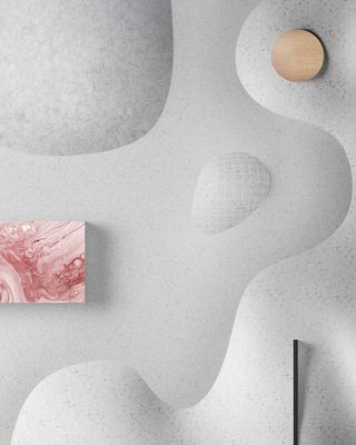 An artistic wall scultpure display with grey bumpy patterns with a round oak coloured spot on the top right and square pink abstract painting on the mid left
