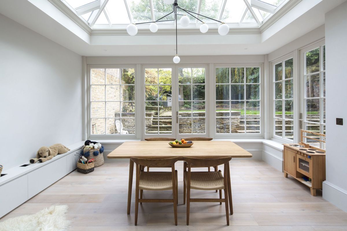 bright and modern conservatory extension with dining table and large roof light