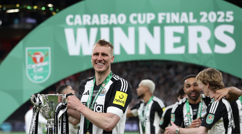 Dan Burn holds up the Carabao Cup trophy at the 2025 final