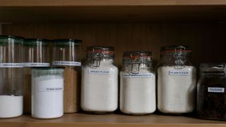 labelled jar of dried ingredients and food products in cupboard