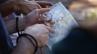 Person using map and compass