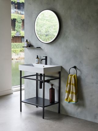 A modern bathroom with a black vanity and black towel rink