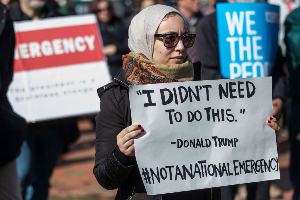 A protester holds an anti-Trump sign.