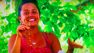 Jaime holding up her fake immunity idol and looking really excited during Survivor 44.