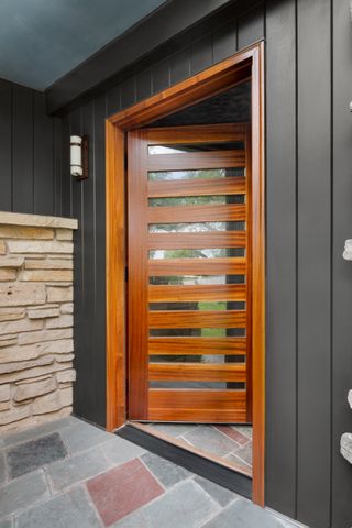 Wooden front door with window in it