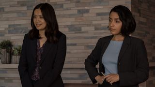 Two woman dressed in smart business attire, ready to pitch their idea.