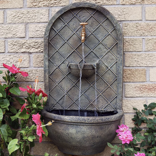 solar powered water fountain on garden wall