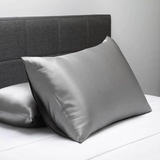 Best silk pillowcase gray silver on bed with black headboard 