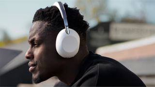 The rugby player and England captain Maro Itoje wearing some white headphones. 