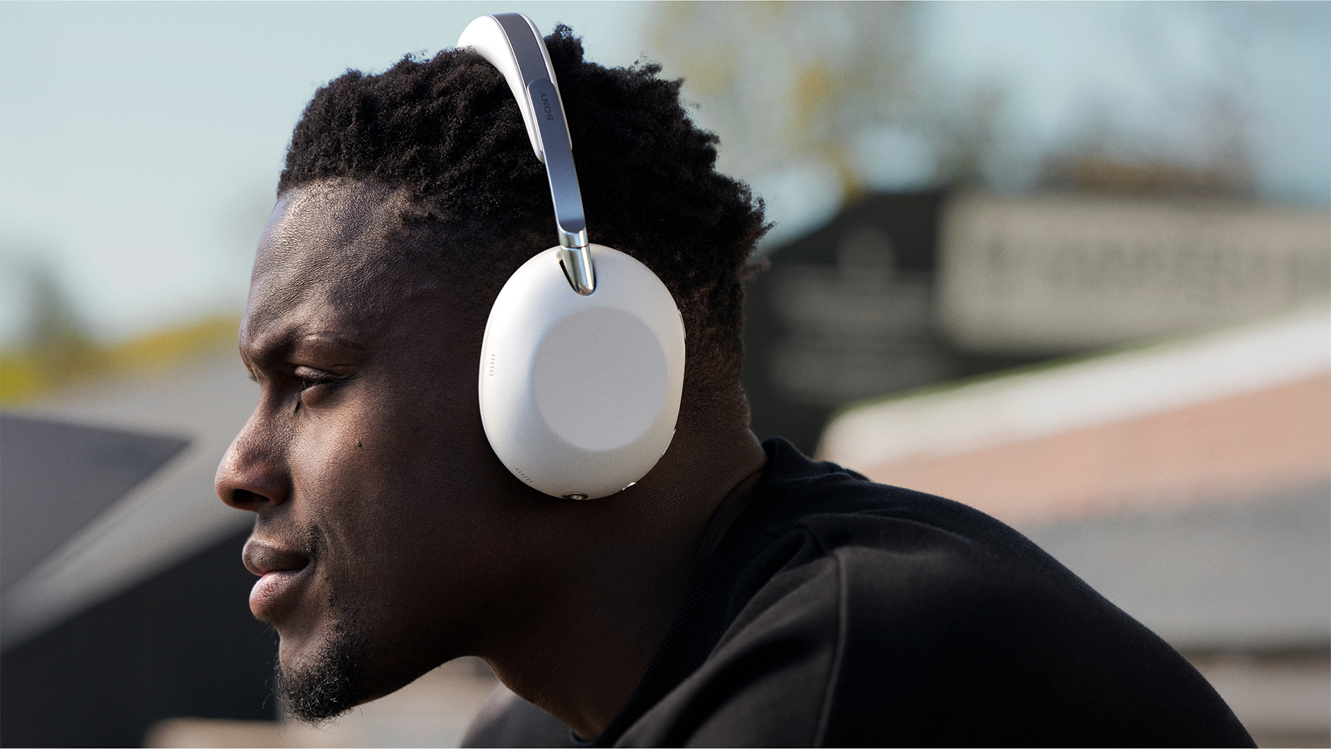 The rugby player and England captain Maro Itoje wearing some white headphones. 