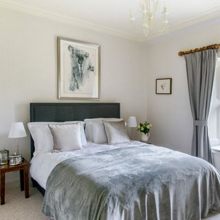 bedroom with white wall and pillows on bed