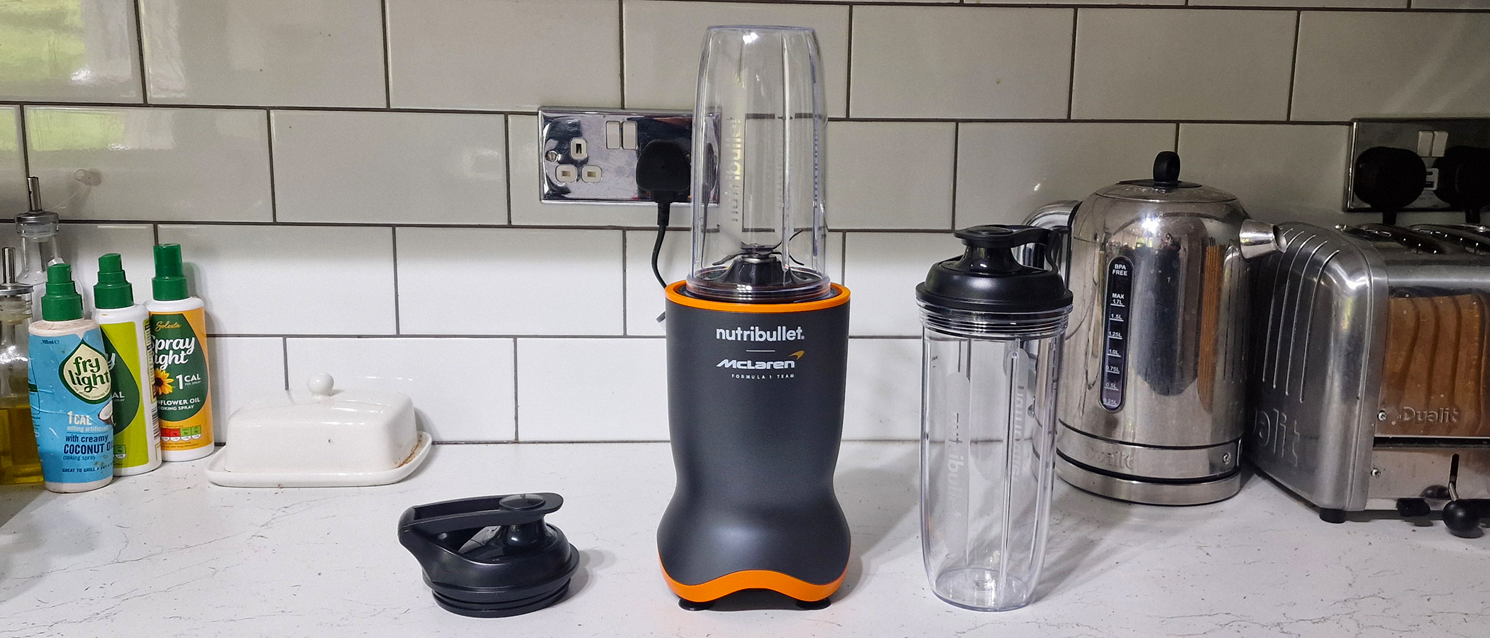 Nutribullet Ultra 1200 with blending cups and lids in a white kitchen