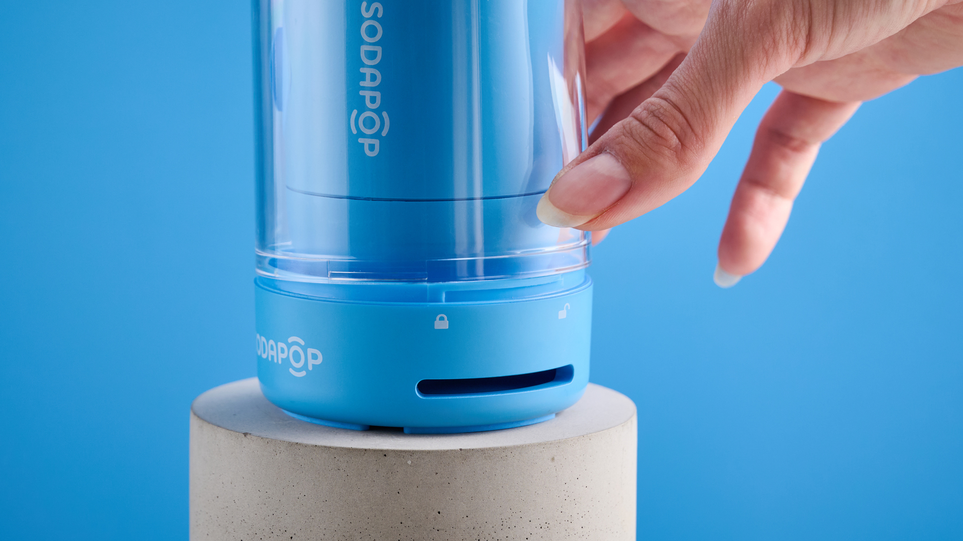 A blue Sodapop Bluetooth speaker that screws onto any regular-sized bottle