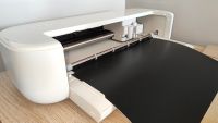 A digital crafting machine on a table