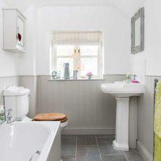 bathroom with floor tiles and bathtub