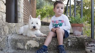 terrier guarding small boy