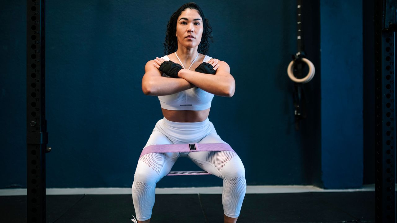 Woman using a resistance band to train her glutes