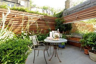 ideas for awkward shaped gardens: mirror on courtyard wall