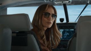 JLo in the cockpit of a plane in Office Romance.