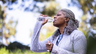 A woman drinks a bottle of water