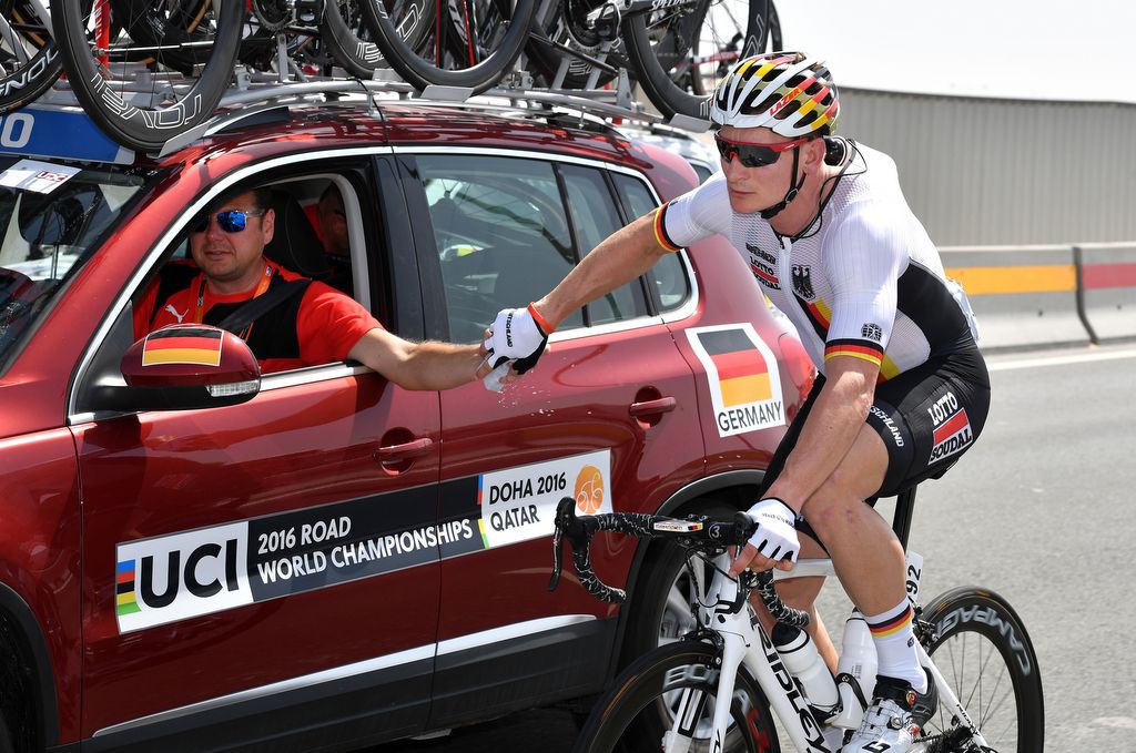 Andre Greipel (Germany) gets some water and ice from the team car