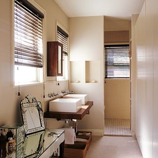 bathroom with white basin and wooden cabinet