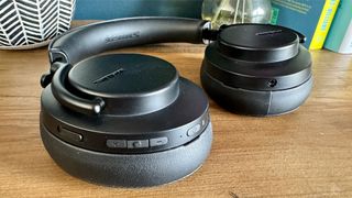 Shure Aonic 50 Gen 2 noise-cancelling over-ears lying flat on table showing earcup controls