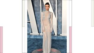 Emily Ratajkowski wears a white/silver sheer dress as she attends the 2023 Vanity Fair Oscar Party hosted by Radhika Jones at Wallis Annenberg Center for the Performing Arts on March 12, 2023 in Beverly Hills, California.