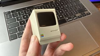 The Shargeek Retro 67 charger on a desk, which looks like a mini Macintosh computer.