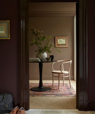 glossy brown painted entryway with a view to a muddy brown seating area