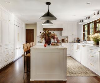 White kitchen with dark wooden windows and large kitchen island