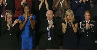 Former NASA astronaut Mark Kelly applauds President Barack Obama after the 2012 State of the Union address. Kelly will speak during the 2016 Democratic National Convention in Philadelphia on July 27, 2016.